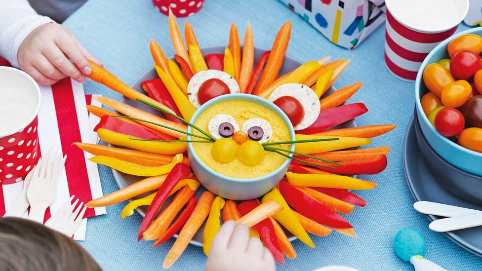 Veggies and dip arranged to look like the face of a lion