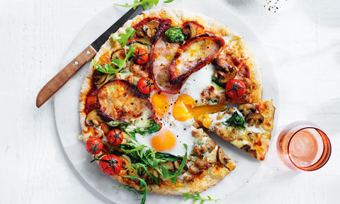Classic big breakfast pizza with bacon, eggs and mushrooms