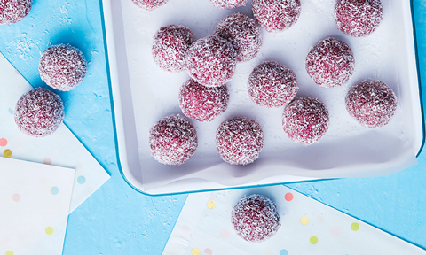 Raspberry bliss balls served on a baking tray