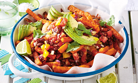 Sweet potato fries topped with beans, corn, avocado and coriander