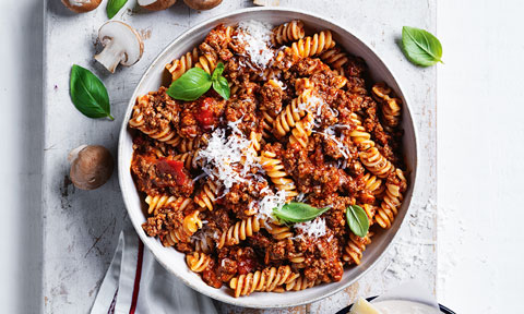 Mushroom bolognese tossed with pasta spirals, basil and parmesan cheese