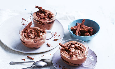 Three cups of chocolate mousse with flaked chocolate on top