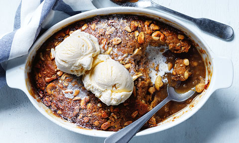 Pumpkin and caramel self-saucing pudding served in a baking dish with two scoops of ice-cream on top
