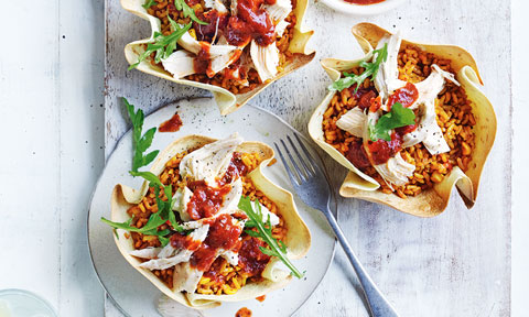 3 chicken tortilla bowls with rocket and cherry tomatoes on top