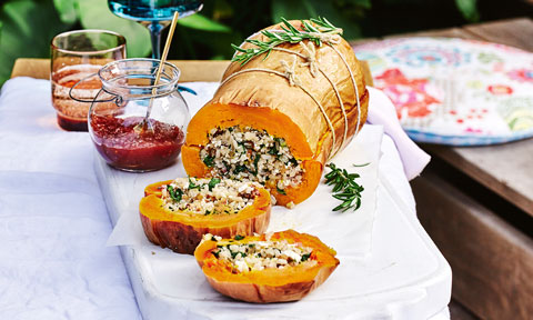 Whole stuffed butternut pumpkin with dressing and rosemary on the side