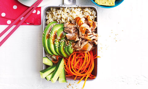 Tuna and rice served in a lunch box with cucumber, shaved carrot and avocado