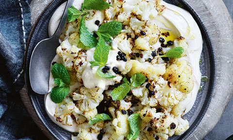 Cauliflower salad served in a bowl with mint on top