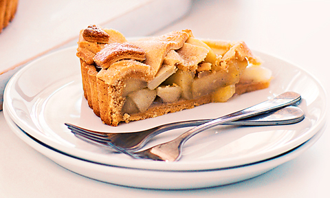 One slice of apple pie served on a plate