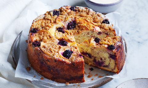Whole blackberry and apple streusel cake served on a plate 
