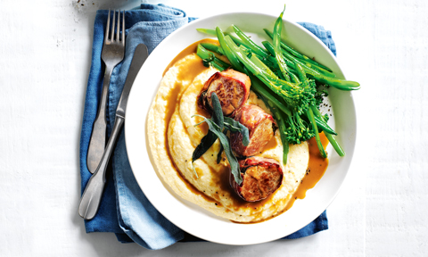 Prosciutto-wrapped pork fillets served on top of polenta with broccoli and mustard sauce