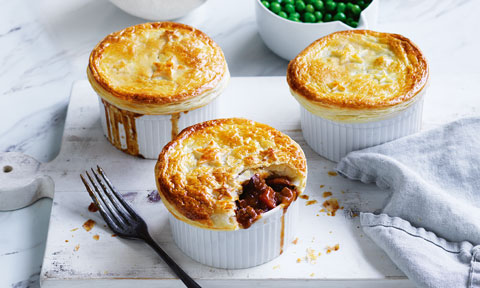 Three Beef and Guinness Pies on small plates