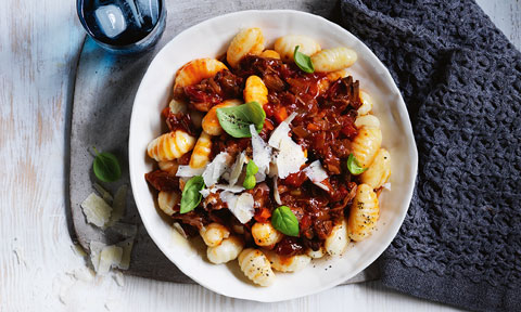 Potato gnocchi topped with beef ragu, basil and parmesan flakes