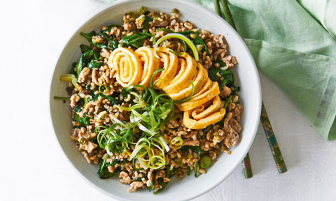 Fried Rice in a bowl, topped with fried egg and spring onion