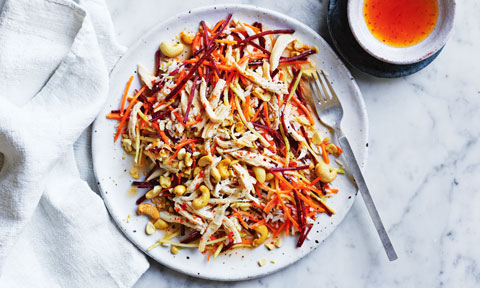Chilli Chicken and Cashew Rice Salad on a plate, with a side bowl of chilli sauce