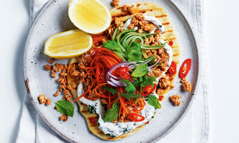 Chilli Naan Breads with Chicken, served with yoghurt and lemon. Garnished with mint, parsley and chilli.