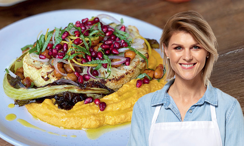 Cauliflower steak served on top of carrot hummus with a picture of Courtney Roulston over the top