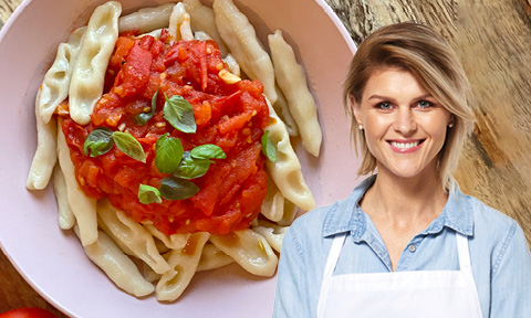 Capunti pasta topped with tomato sauce and fresh basil with picture of Courtney Roulston over the top