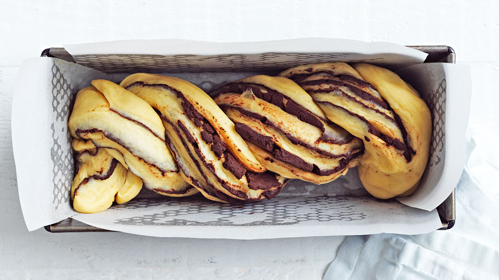 Place the twisted dough in a loaf pan