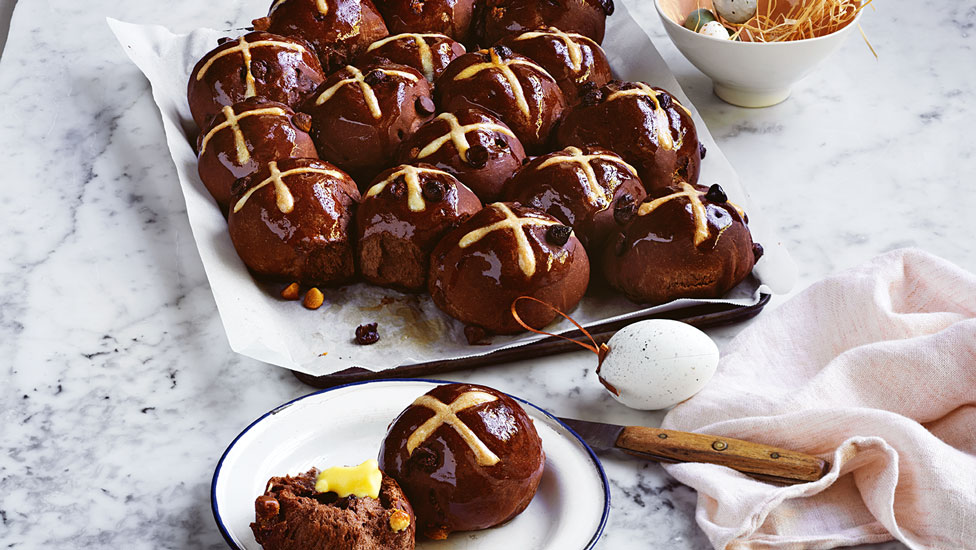 Double chocolate hot cross buns on a baking tray
