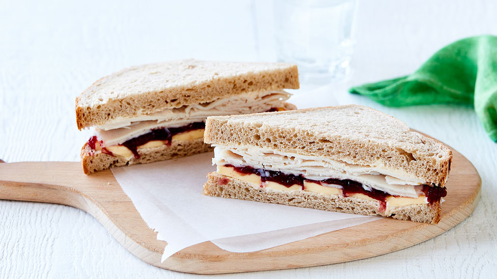 A turkey and cranberry sandwich cut in half