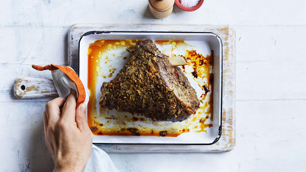 Roasted lamb leg in baking dish