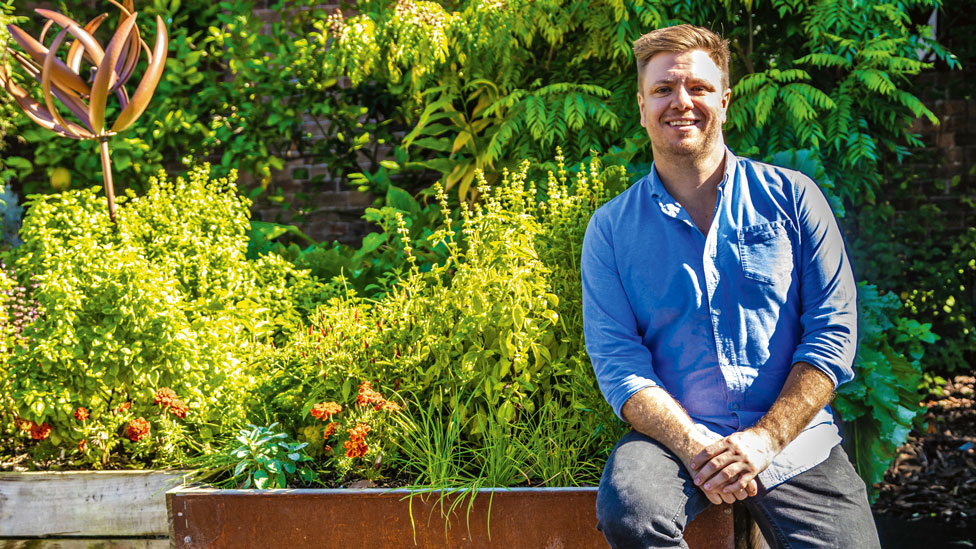 Michael Weldon in a herb garden