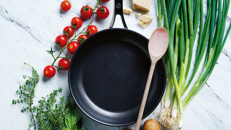 Frypan opener, spoon and vegetables