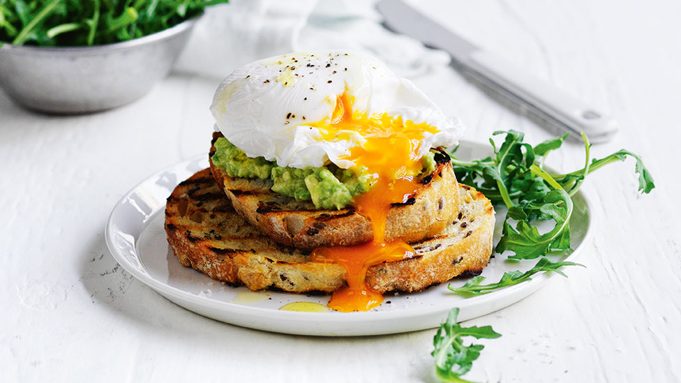 Poached eggs on toast with smashed avocado