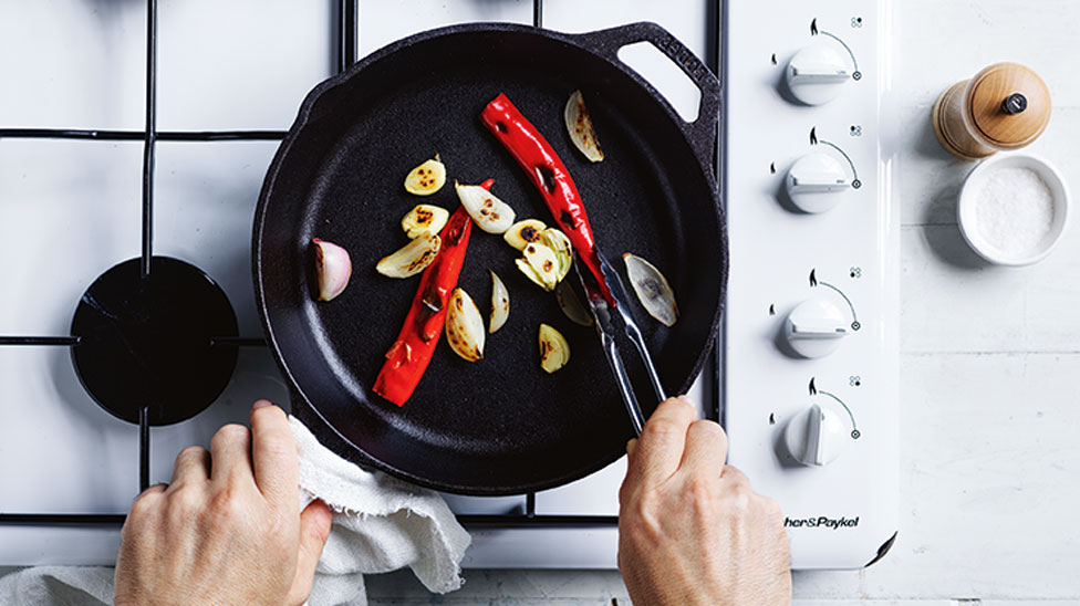 Chilli and garlic being fried in a pan