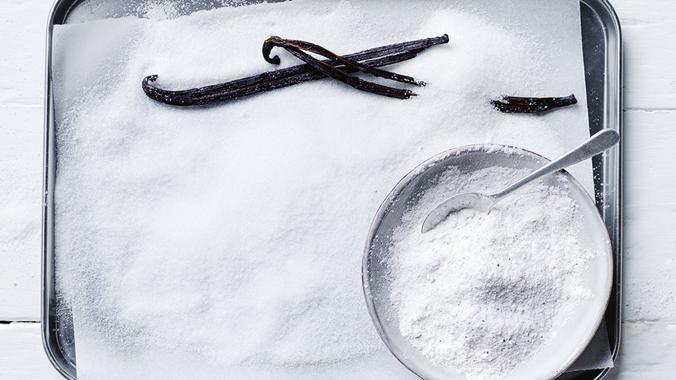 A bowl of vanilla sugar on a baking pan