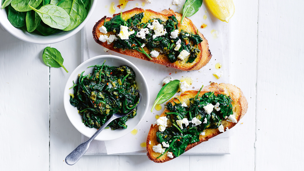 A spinach jam dish and two toasts with spinach jam and fetta on top