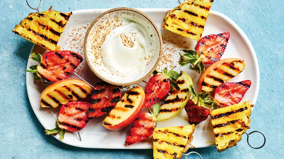 Grilled starwberries, apple and pineapple cut in half