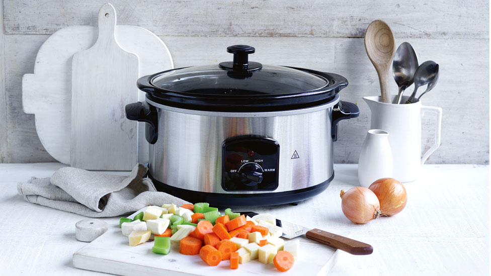 Slow cooker on bench with vegetables in front