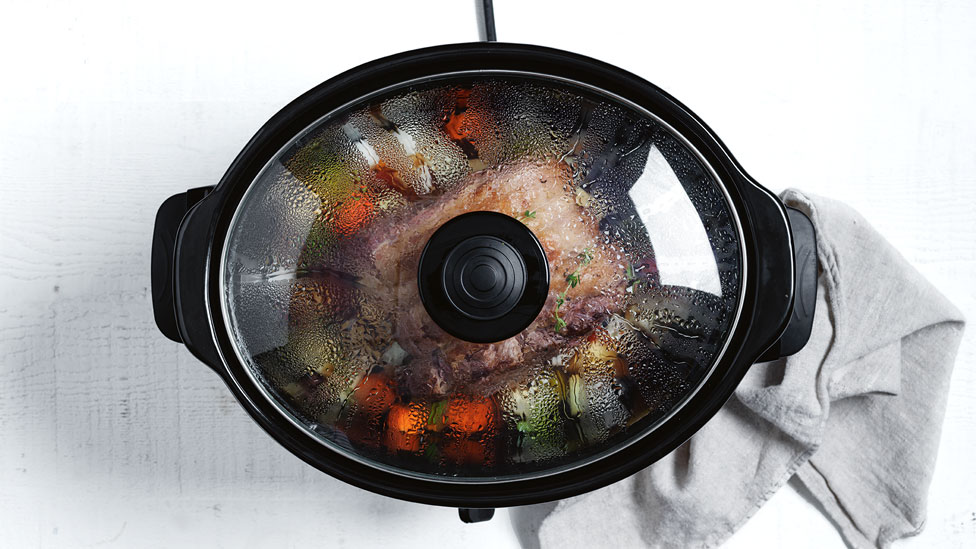 Meat and vegetables in slow cooker with the lid on