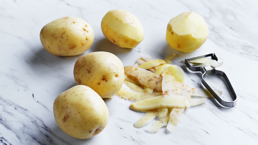 Potatoes with potato peeler