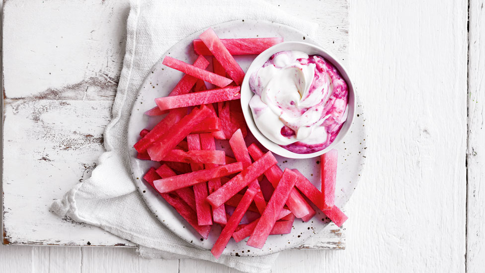 Watermelon fries on a plate with a side bowl