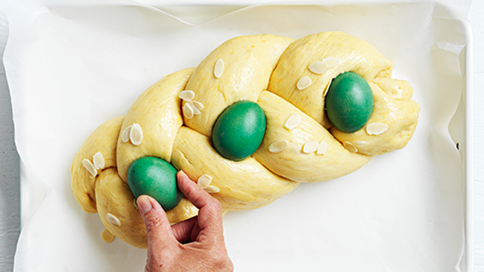 Placing dyed eggs on top of the bread