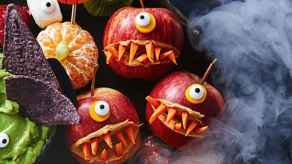Three monster apples with carrot teeth