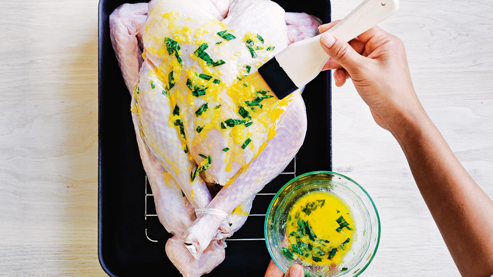 Brush the turkey with butter and chopped herb mixture