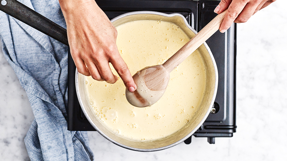 Testing the custard mixture is ready