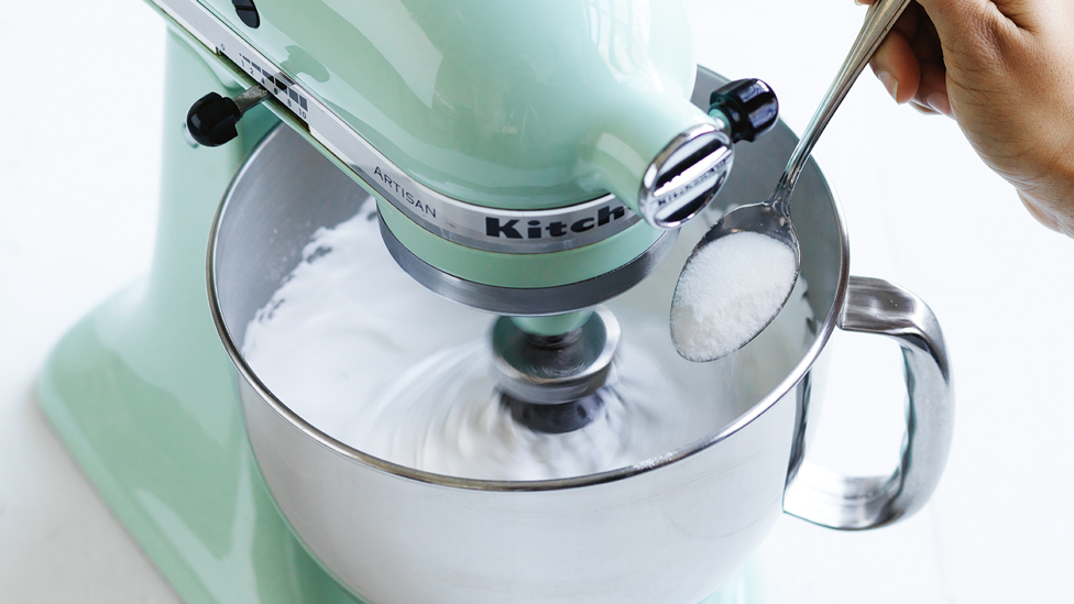 Adding sugar to the electric mixer