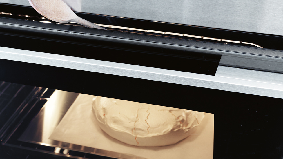 Proping the oven door ajar with a wooden spoon