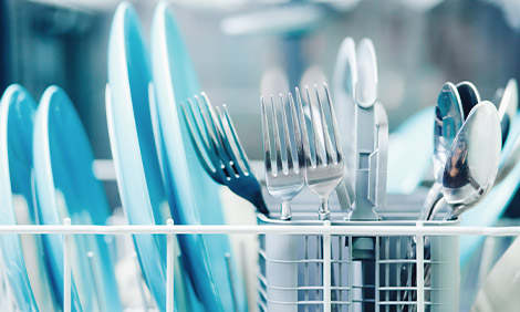 Plates and cutlery in a dishwasher