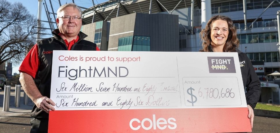 Steven Cain giving a cheque to FightMND 