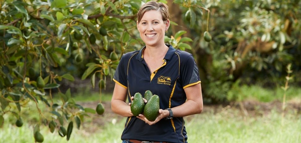 Farmer Kim Mastin holding avocados