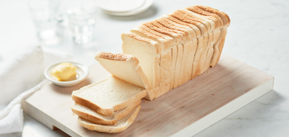 Freshly sliced bread on chopping board
