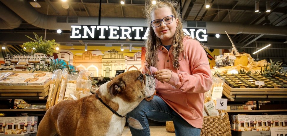 girl holding an icecream for a dog in the new Coles Local supermarket