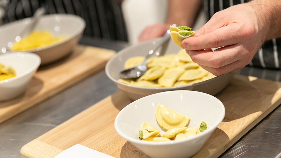 Pasta filled with cheese and spinach cut in half