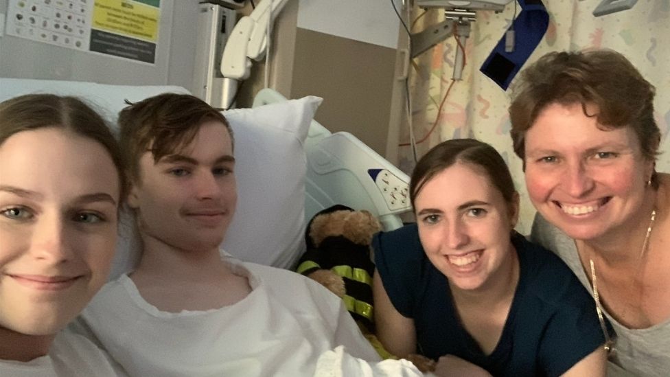 A family of four sitting in a hospital