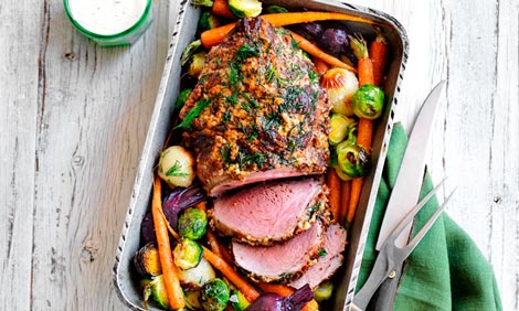 Roast lamb in a baking dish with vegetables